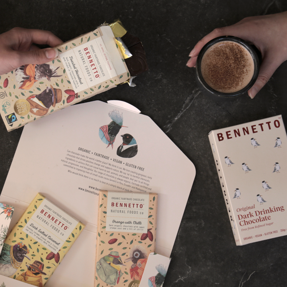 Bennetto chocolate bars and a ceramic reusable mug of hot chocolate being shared between two people
