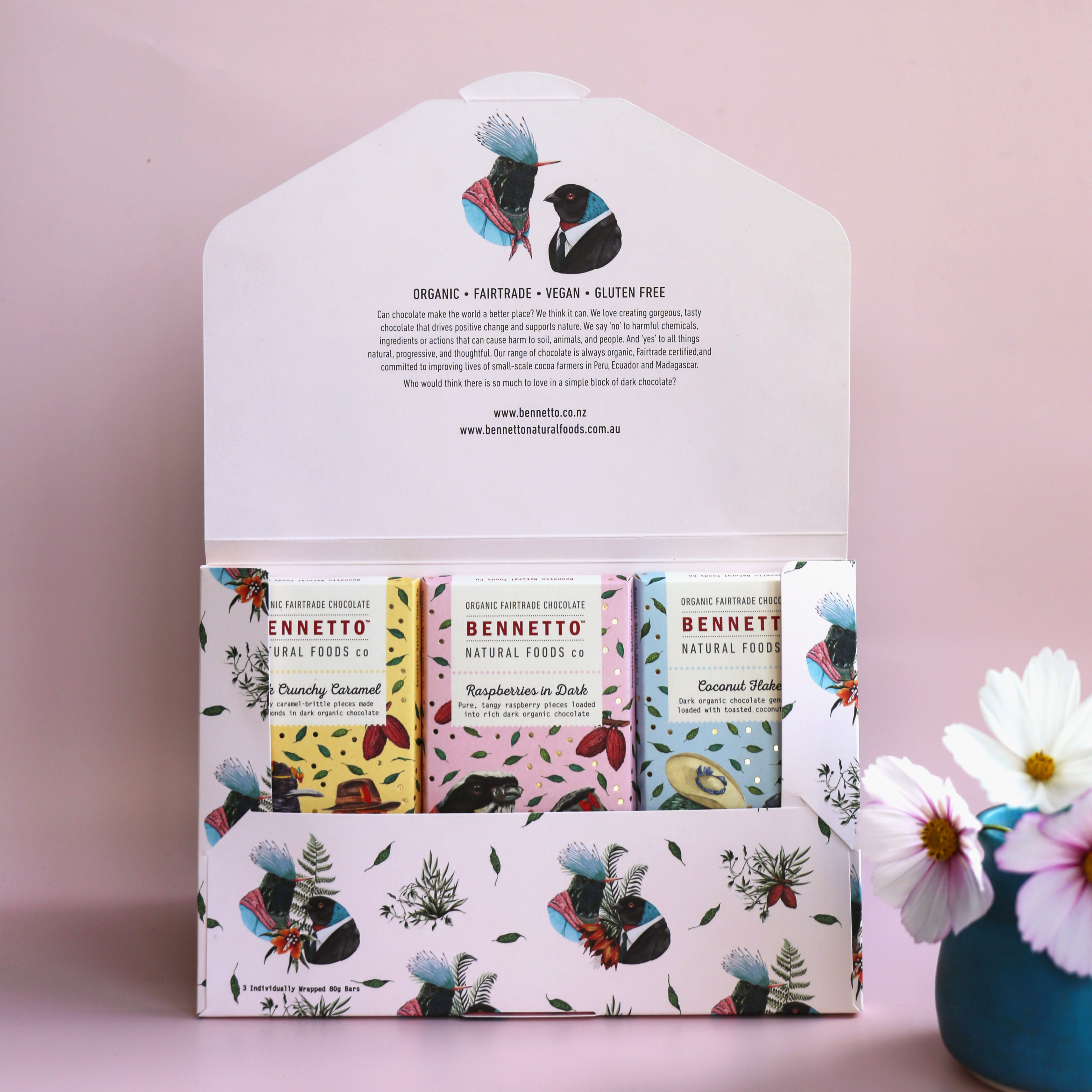 Bennetto chocolate 3-pack for Mother's Day, with 3 bars in a Bennetto-designed signature envelope against a light pink background and flowers to the side. 