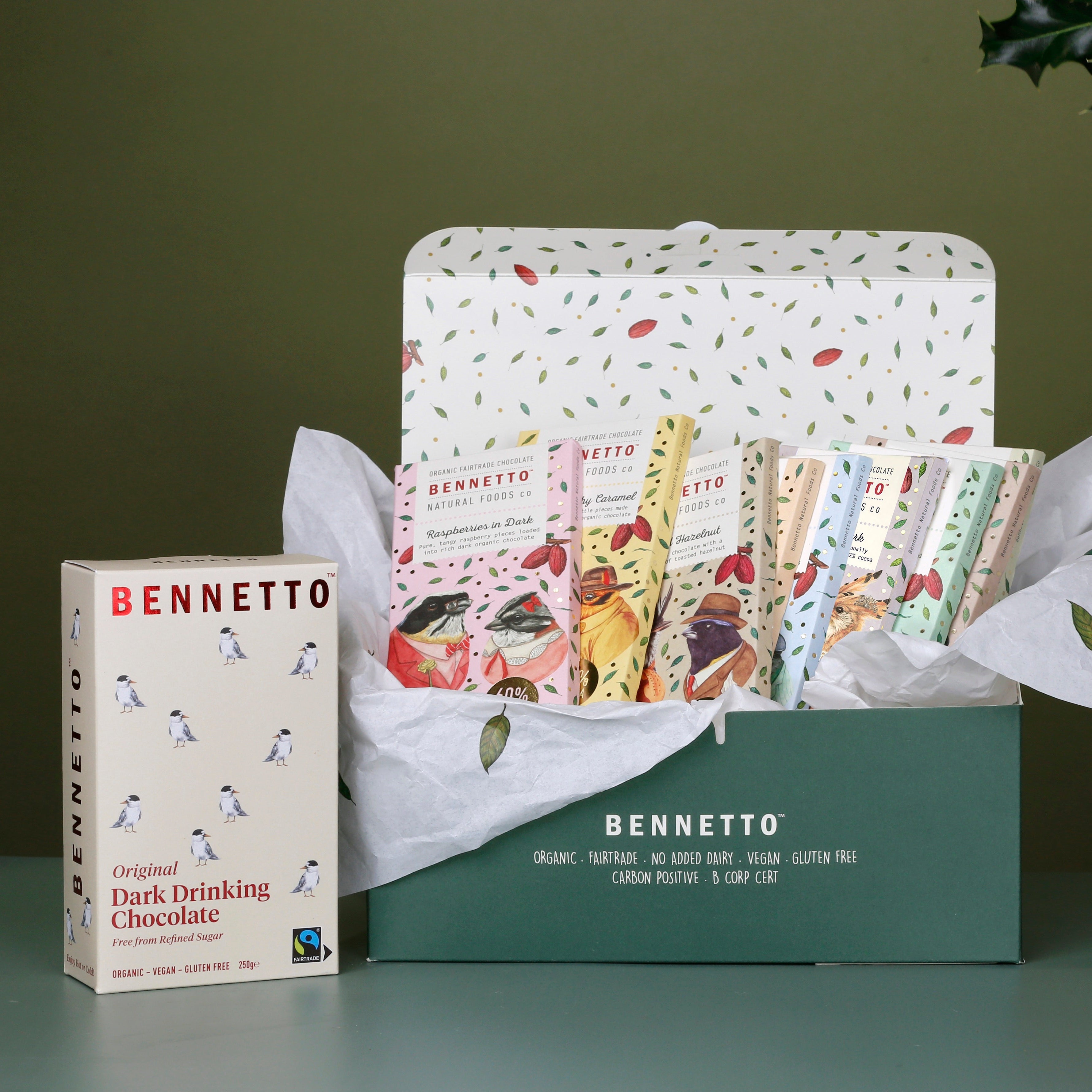 9 x Bennetto Chocolate 80g bars, including every flavour: Raspberries in dark, Dark Salted Caramel, Toasted Hazelnut, Orange with Chilli, Coconut Flakes, 82% Super Dark, Dark Mint, Dark Coffee, 70% Organic Dark. All in a dark green gift box with tissue paper, and a Original Dark Drinking Chocolate.