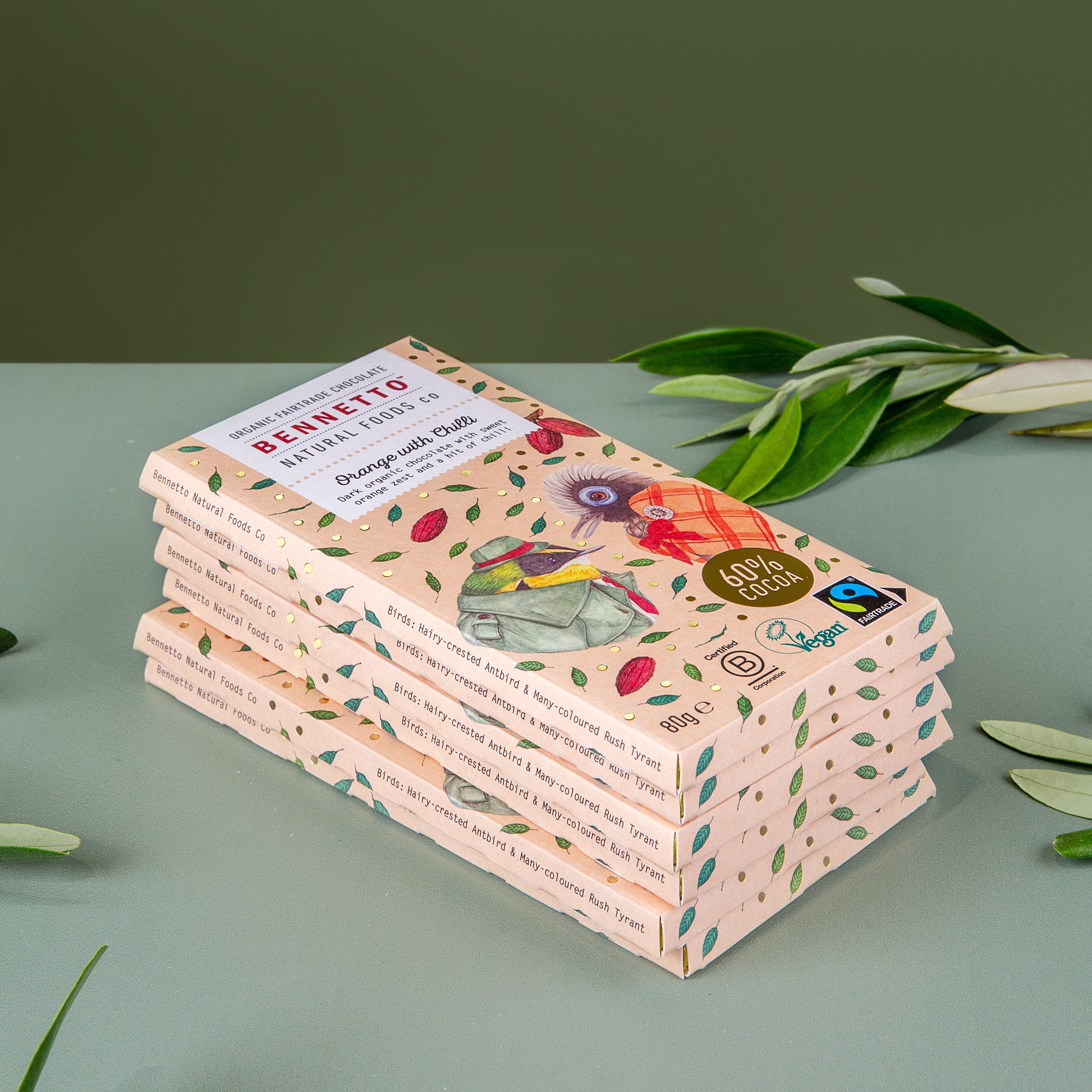 Stack of 6 Bennetto Orange with Chilli organic and vegan dark chocolate bars on a green background 